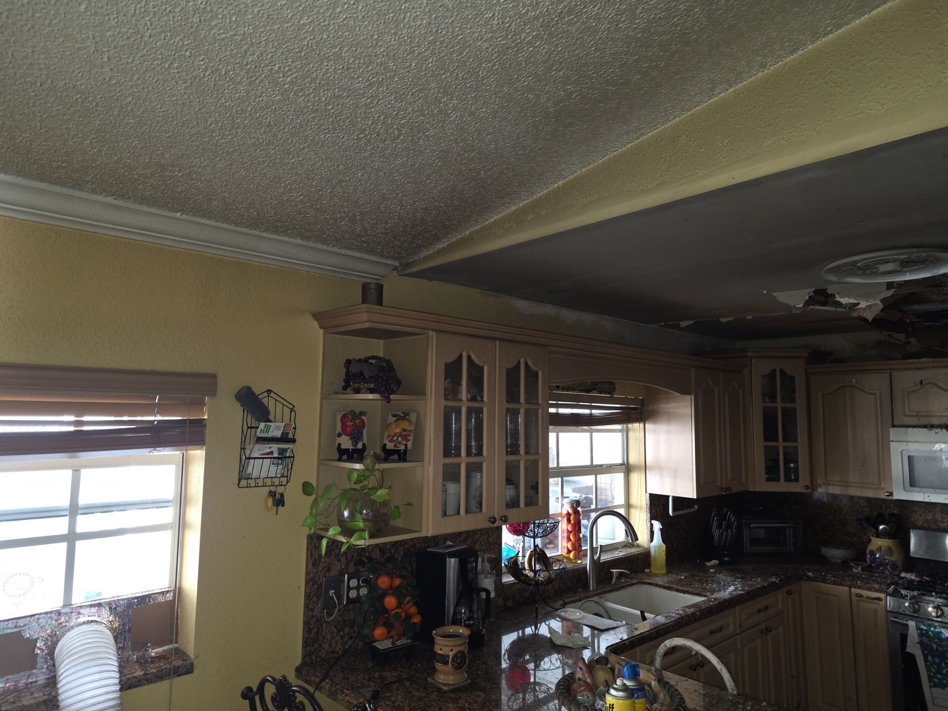 Smoke damage to kitchen ceiling with soot staining
